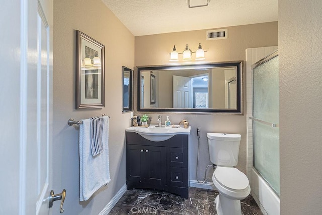 full bathroom featuring a textured ceiling, shower / bath combination with glass door, vanity, and toilet