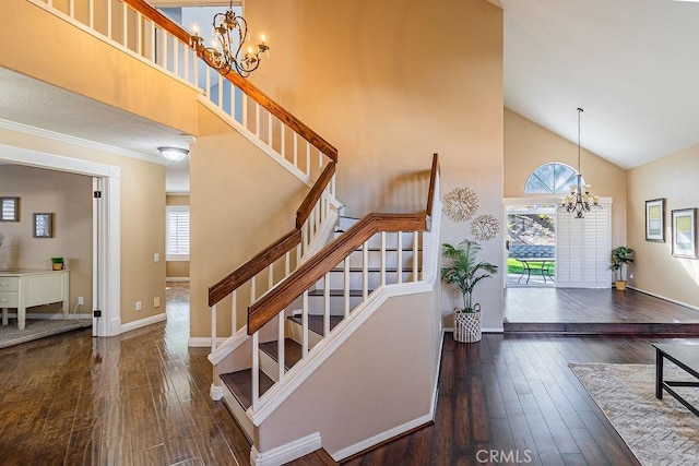 stairs featuring an inviting chandelier, high vaulted ceiling, and hardwood / wood-style flooring