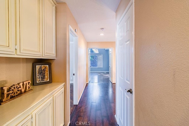 hallway with dark hardwood / wood-style flooring