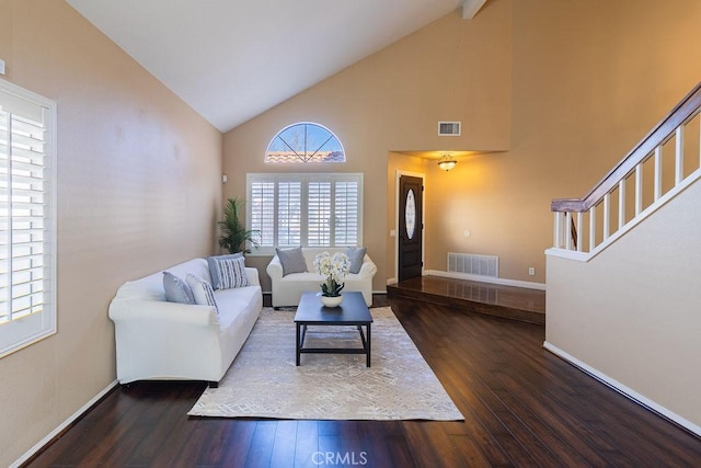 living room with high vaulted ceiling and dark hardwood / wood-style floors