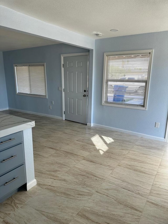 entryway with a textured ceiling