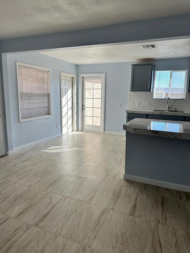 kitchen featuring sink and tasteful backsplash