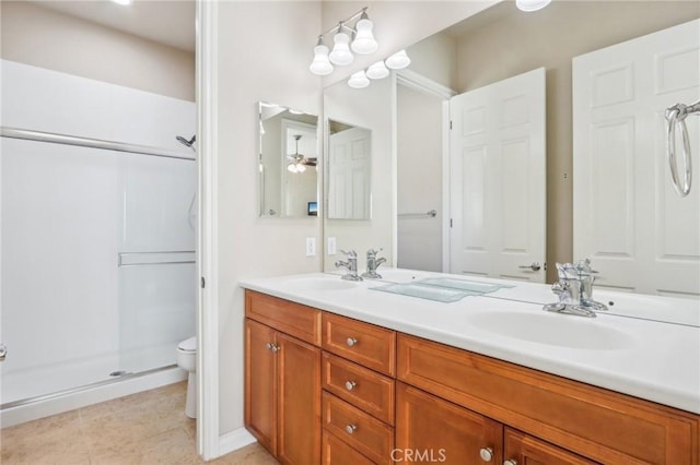 bathroom featuring toilet, an enclosed shower, vanity, and ceiling fan