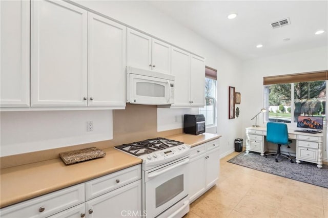 kitchen with white appliances and white cabinets