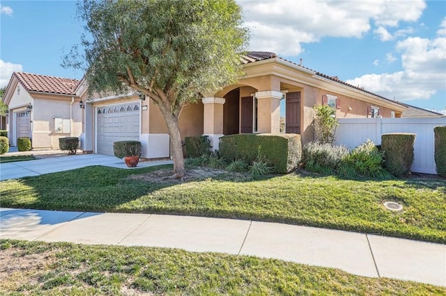 mediterranean / spanish-style home with a front lawn and a garage