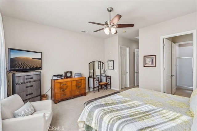 bedroom with ceiling fan and light carpet