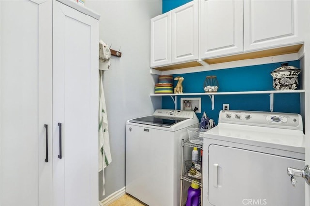 washroom featuring independent washer and dryer and cabinets