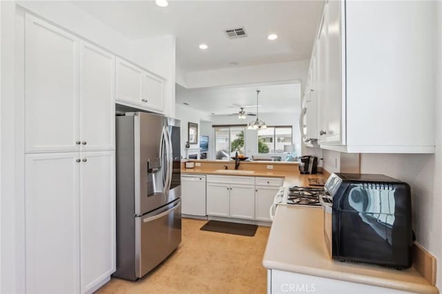 kitchen featuring dishwasher, stainless steel refrigerator with ice dispenser, white cabinets, ceiling fan, and sink