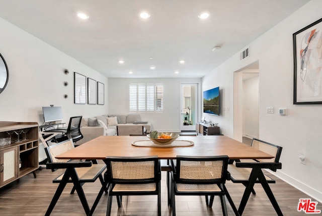 dining space with hardwood / wood-style floors