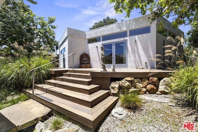 view of side of property with french doors