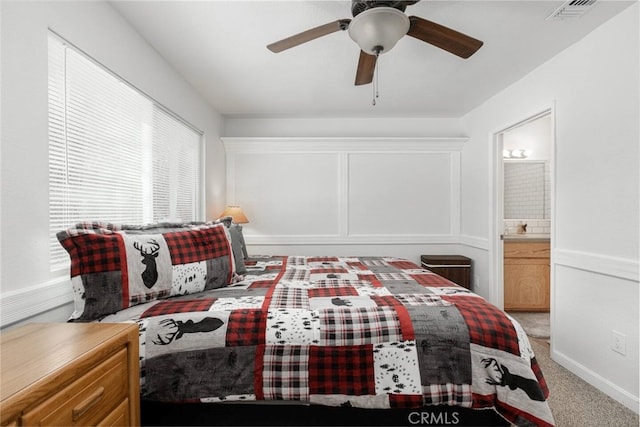 carpeted bedroom featuring ensuite bathroom and ceiling fan