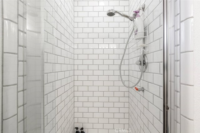 bathroom with tiled shower