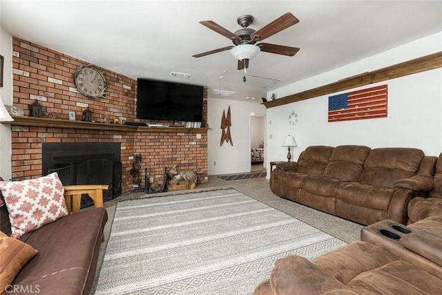 carpeted living room with a fireplace and ceiling fan