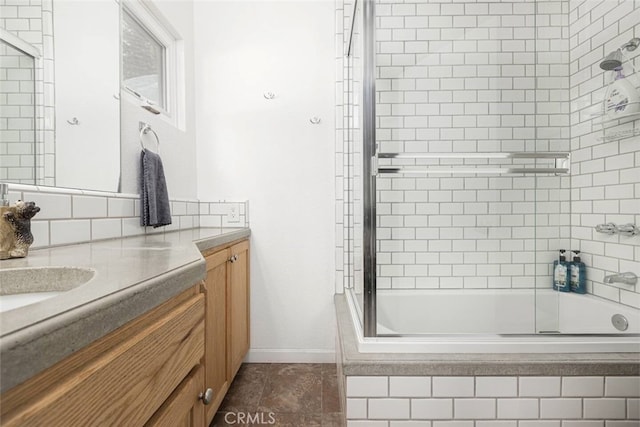 bathroom with bath / shower combo with glass door and vanity