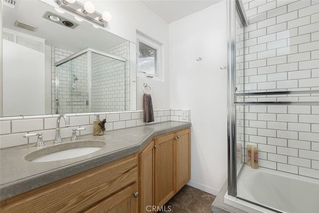 bathroom featuring vanity, a shower with shower door, and tile patterned floors