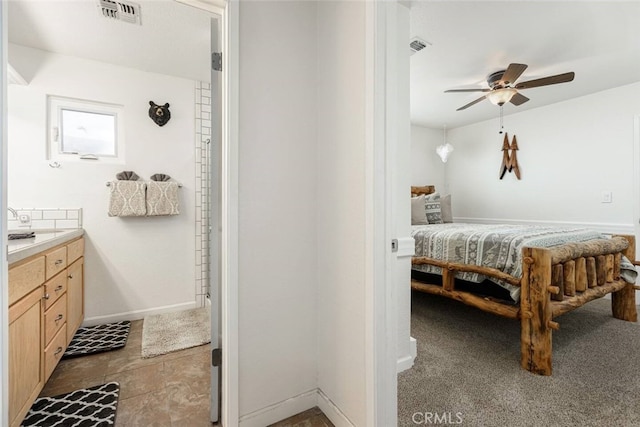 bedroom with ceiling fan and dark colored carpet