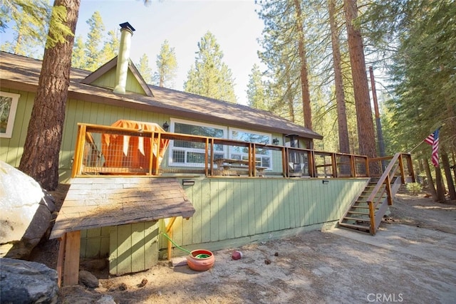 rear view of property with a wooden deck