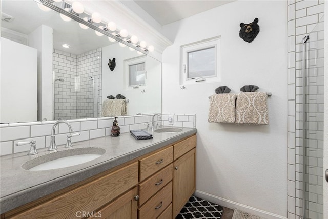 bathroom with a tile shower and vanity