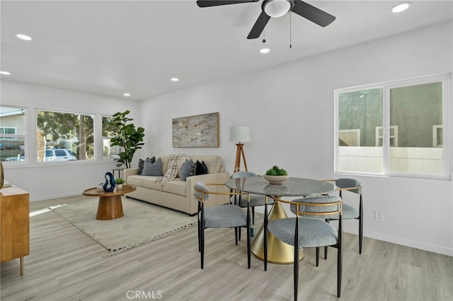 living room with ceiling fan, light hardwood / wood-style floors, and a healthy amount of sunlight