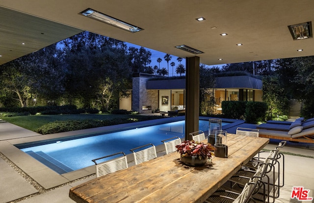 view of pool with a bar and a patio area