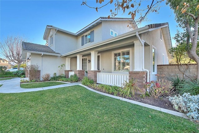 view of front of house featuring a porch and a front lawn