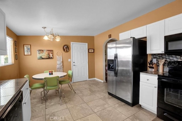 kitchen with decorative light fixtures, white cabinets, an inviting chandelier, backsplash, and black appliances