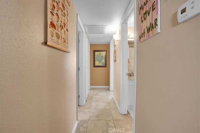 corridor featuring light tile patterned flooring