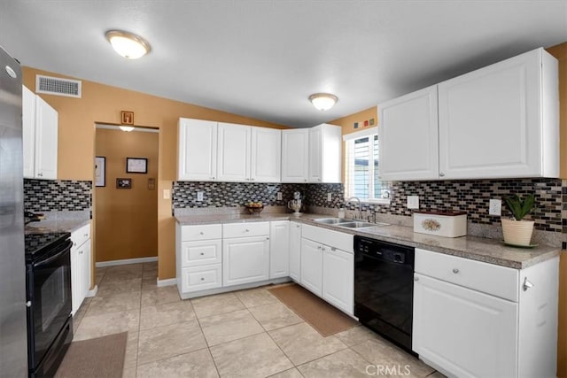 kitchen with sink, white cabinets, lofted ceiling, light tile patterned flooring, and black appliances