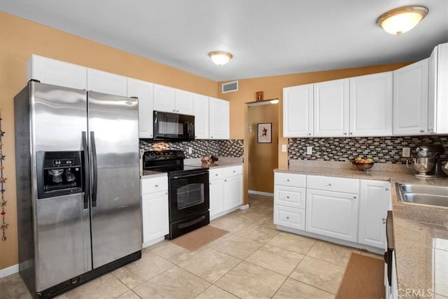 kitchen with black appliances and white cabinets