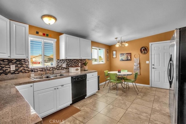 kitchen featuring stainless steel fridge, white cabinetry, dishwasher, and pendant lighting