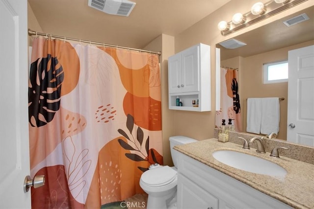 bathroom featuring curtained shower, vanity, and toilet