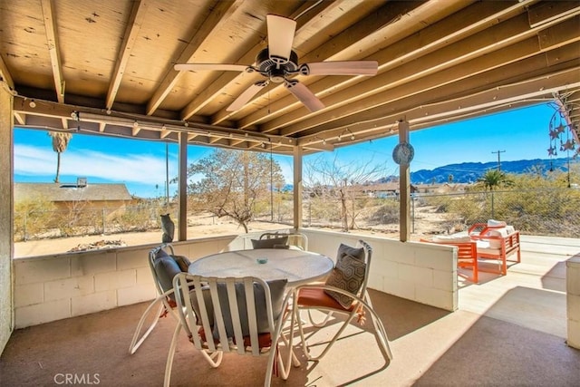 view of patio / terrace with ceiling fan and a mountain view