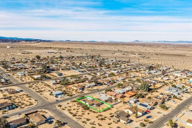 birds eye view of property with a mountain view