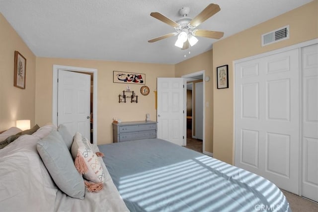 carpeted bedroom with a closet and ceiling fan