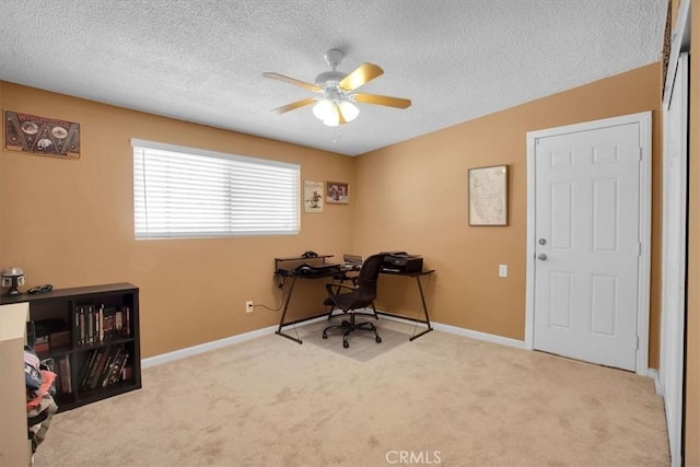 carpeted office with a textured ceiling and ceiling fan