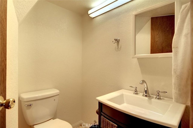 bathroom with toilet and vanity