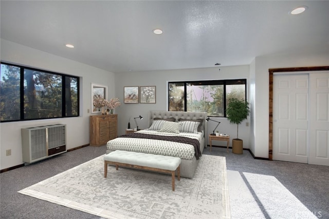 bedroom featuring heating unit and carpet