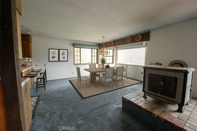 carpeted dining room featuring a wood stove