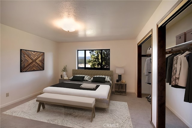 bedroom featuring a closet and light colored carpet