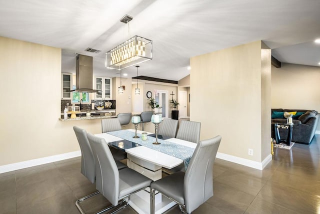 dining area with lofted ceiling and a chandelier