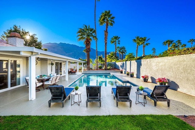 view of pool featuring a patio and a mountain view