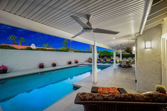 view of swimming pool featuring a patio area and ceiling fan