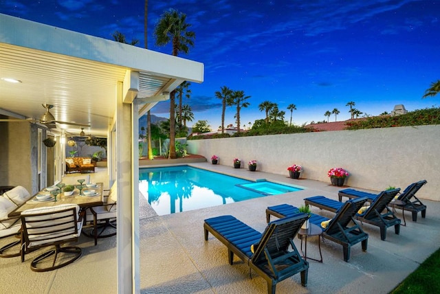 pool at dusk with a patio