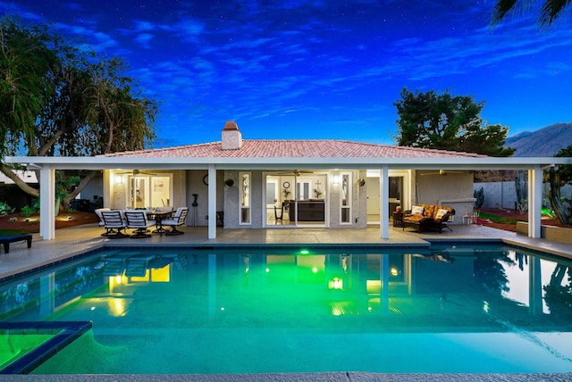 view of pool with a patio area and ceiling fan