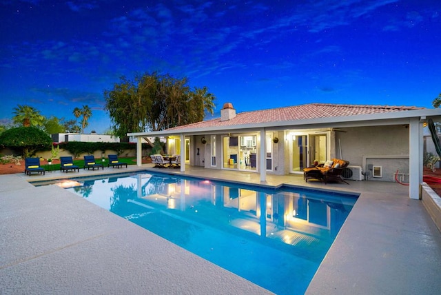 view of swimming pool with a patio, ceiling fan, and an outdoor structure