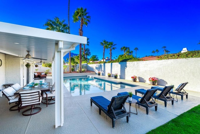 view of swimming pool with a patio and ceiling fan