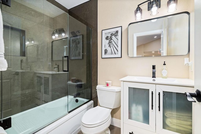 full bathroom featuring enclosed tub / shower combo, vanity, and toilet