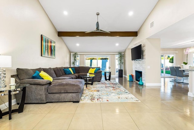 living room featuring ceiling fan, lofted ceiling with beams, light tile patterned flooring, and a fireplace