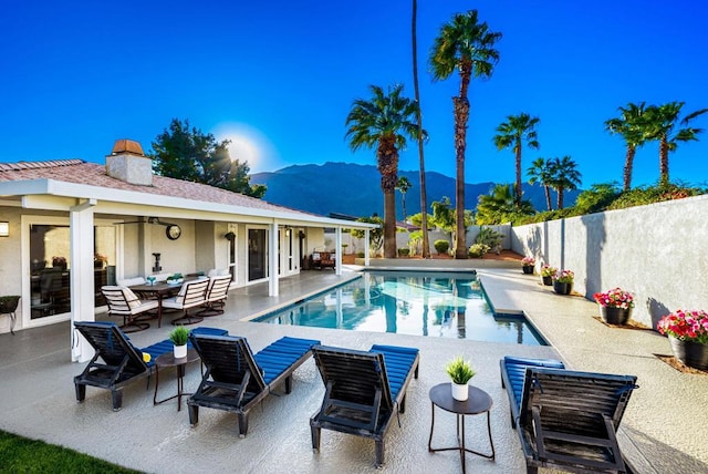 view of pool featuring a patio and a mountain view