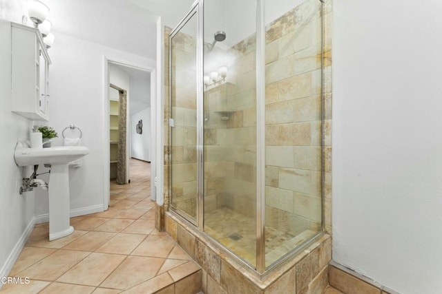 bathroom featuring a shower with shower door and tile patterned flooring